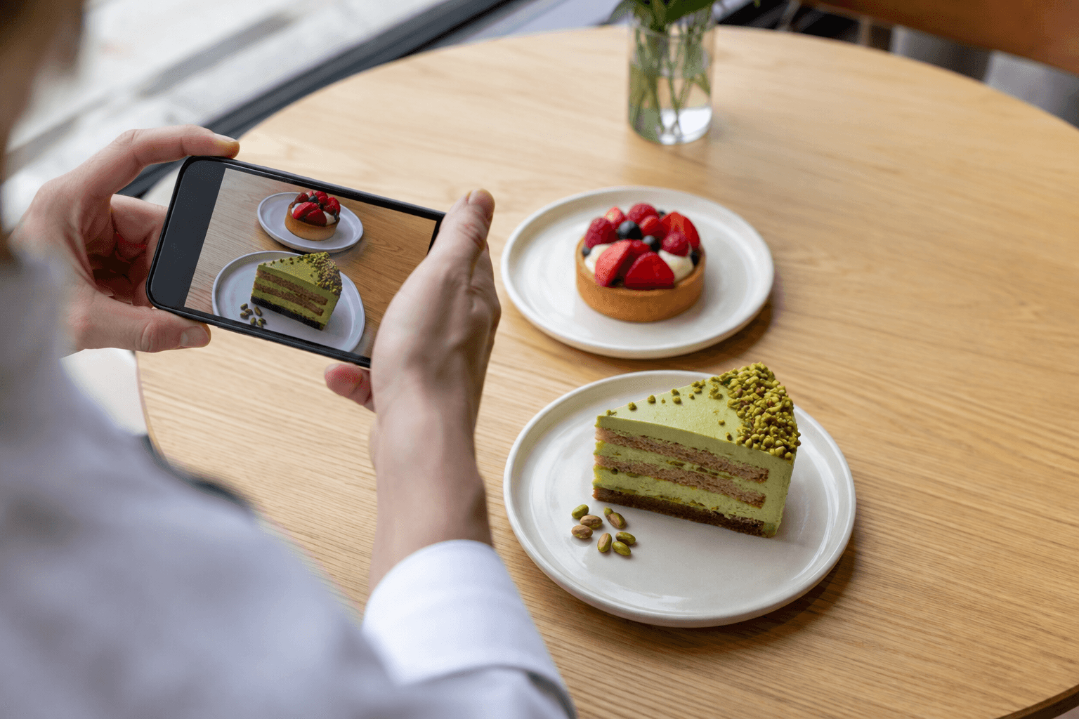 Illustrative restaurant scene: desserts being photographed for a social post